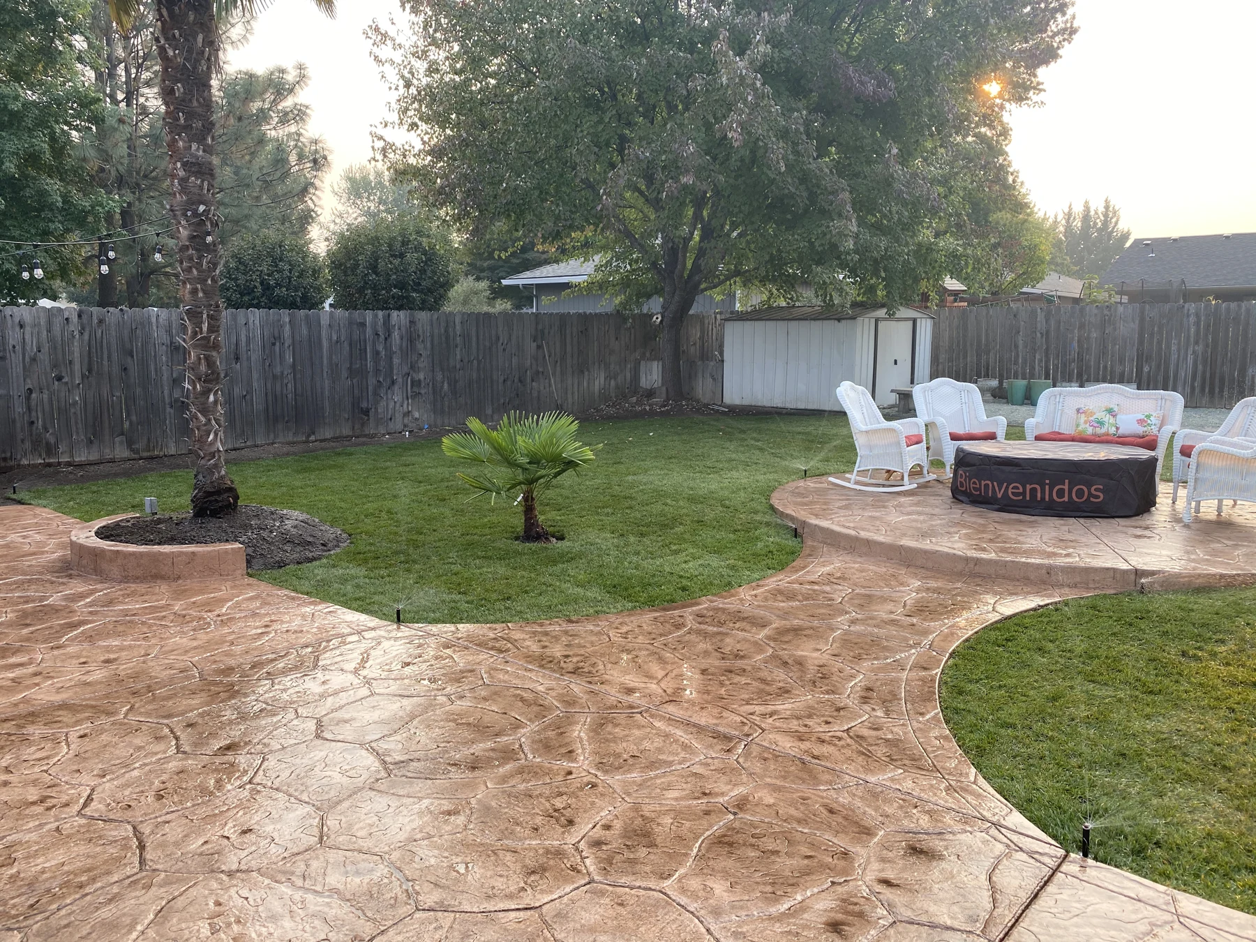 Textured concrete patio around a landscaped lawn